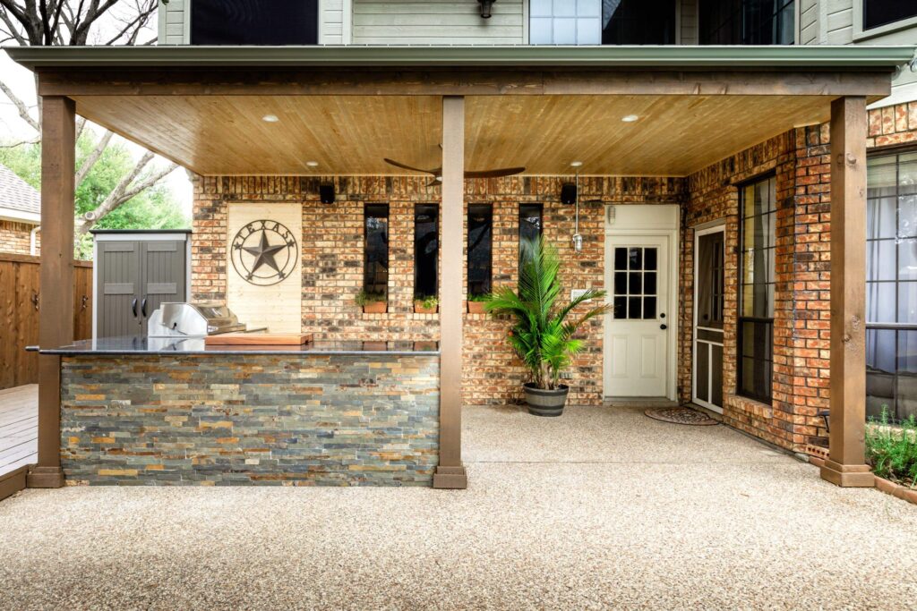 Modern outdoor kitchen that has been freshly built by ProNail Outdoor Living under a patio.