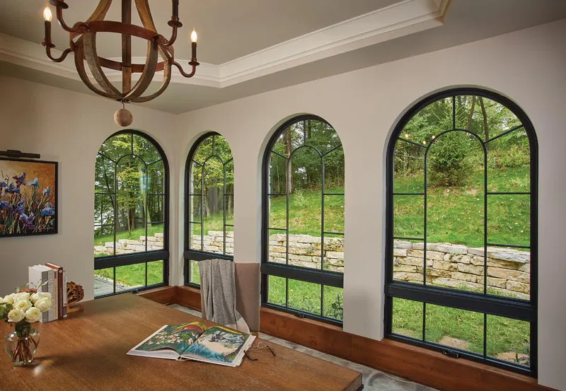 Arched windows with black design in modern dining area by ProNail Outdoors.